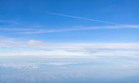 Small plane in the boundless sky above clouds Stock Photos