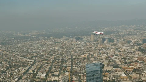 A small plane Cessna is flying over city 스톡 동영상 119349792