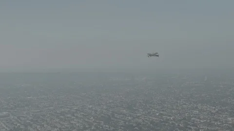 A small plane Cessna is flying over city, Raw colors Stock Footage 119350041