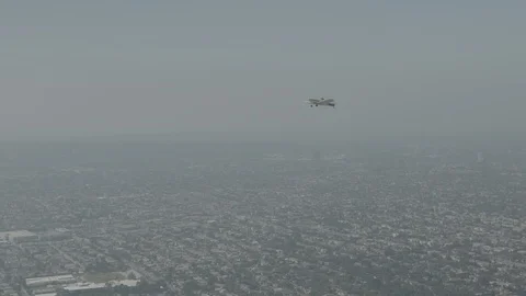 A small plane Cessna is flying over city, raw colors Stock Footage 119350061