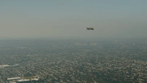 A small plane Cessna is flying over city Stock Footage 119350102