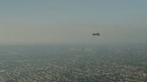 A small plane Cessna is flying over city Stock Footage 119350103