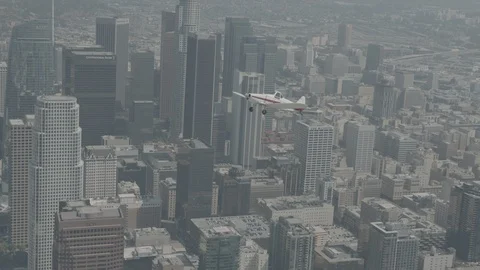 A small plane Cessna is flying over city, raw colors Stock Footage 119350139