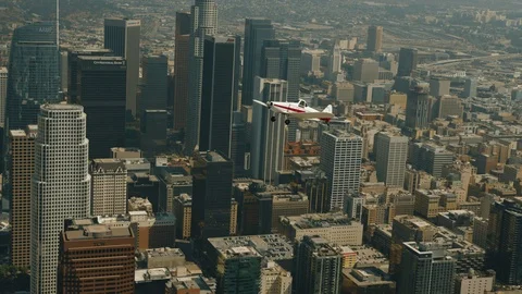 A small plane Cessna is flying over city Stock Footage 119350305