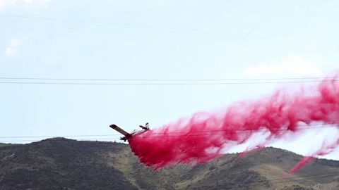 Small Plane Dropping Red Fire Retardant Video stock 135852153