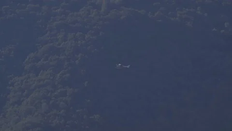 Small plane flying with background mountains Stock Footage 71551448