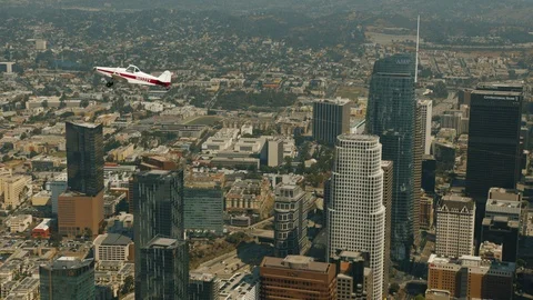 A small plane is flying over city Stock Footage 119349617