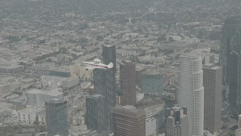 A small plane is flying over LA, raw colors Stock Footage 119349515