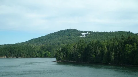 Small Plane Flying Over Lake in British Columbia Stock Footage 96182079