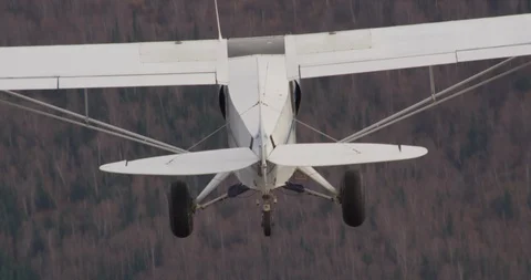 Small plane flying over mountains, helicopter aerial, drone Stock Footage 107750932