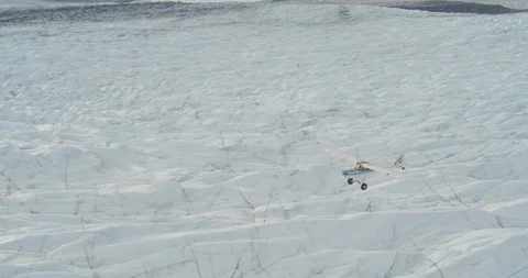 Small plane flying over ragged ice, helicopter aerial, drone Stock Footage 107859900