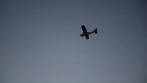 A small plane is flying into the sunset Stock Footage 166056122