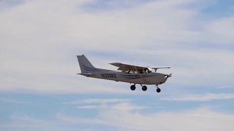 Small plane flys overhead on a sunny day Stock Footage 221378082