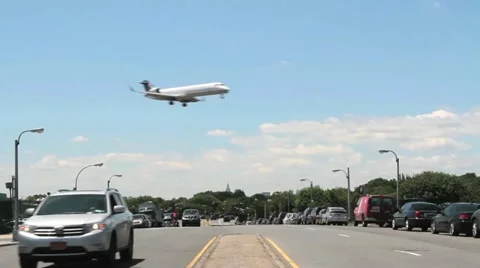 Small plane landing low over a city street Stock Footage 11188456