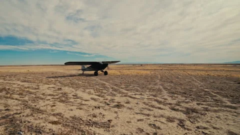Small Plane Lands in Desert Stock Footage 242117601