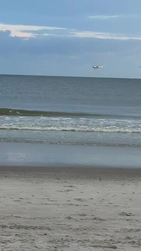 Small Plane Makes Emergency Landing Near Oak Island Pier, Oak Island, North Caro Stock Footage 314391622