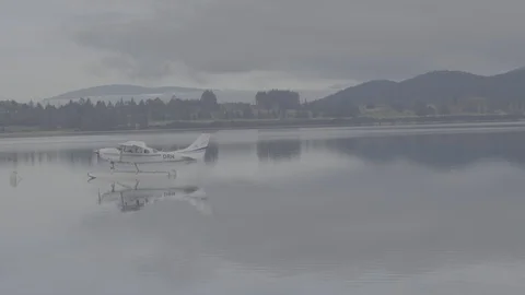 Small Plane Mirrored on a Lake 4k Stock Footage 124510052