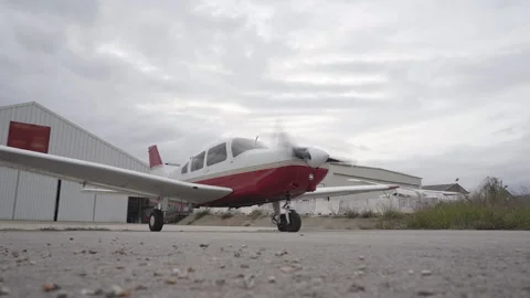 Small plane outside the hangar starting engines. Stock Footage 146375276