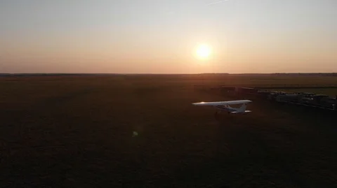 Small plane takes off at sunset Stock Footage 113728315