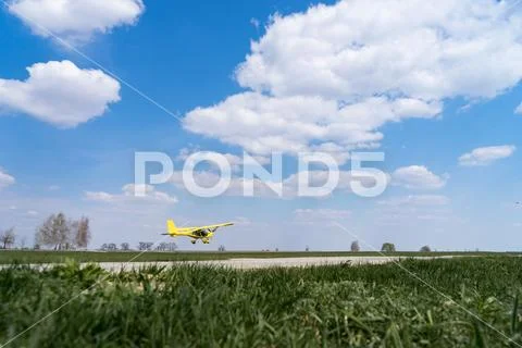 Small Plane Taking Off from green field. Concept of increase and development Stock Photos