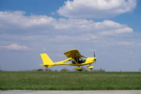 Small Plane Taking Off from green field. Concept of increase and development Stock Photos