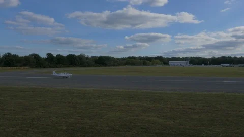 Small plane taking off from medium sized airport, drone aerial 4K Stock Footage 101110405