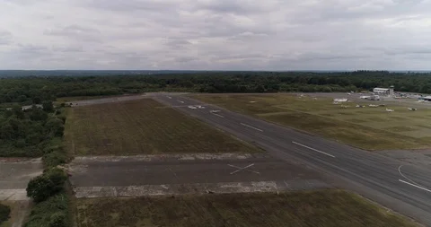 Small plane taking off from a small airport, flies past camera drone aerial 4k Stock Footage 124647062
