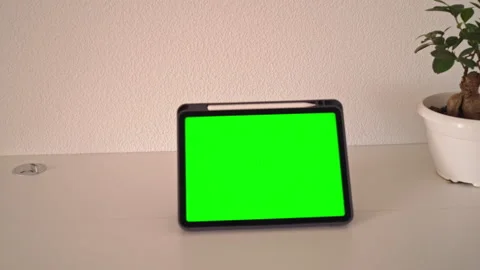 Small plant in pot and tablet with green screen in different angles on table Stock Footage 343999409