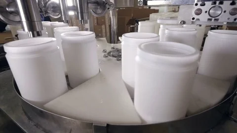 Small plastic containers being filled with liquid. Stock Footage