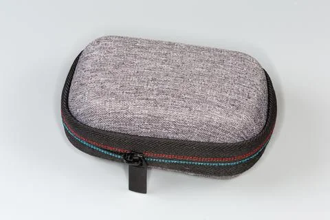 Small plastic hard case with zipper on a gray background Stock Photos