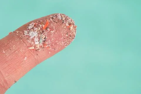 Small Plastic pellets on finger. Micro plastic, problem. Stock-Fotos