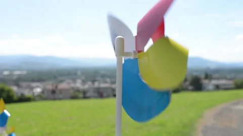 Small plastic windmill spinning in the wind Stock Footage 66055304