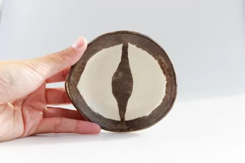 Small plate in the shape of a dragon's eye is made using the technique of mixing Stock Photos