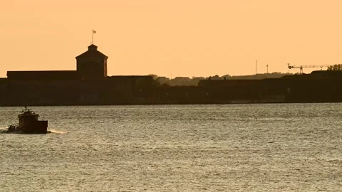 Small polit boat heading back home to port at sunset Video stock 276782586