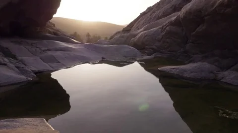 Small pond between rocks in mountainous region during sunset Stock Footage 71546025
