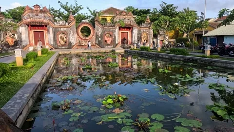 Small pond in front of a beautiful temple in Hoi An Stock Footage 240882678