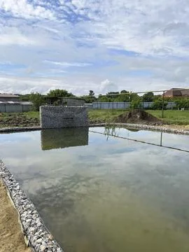 Small pond with sky reflection and rural landscape 写真素材