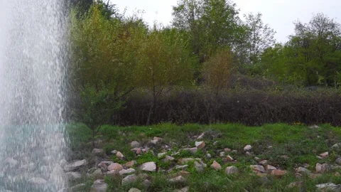 A small pond with a waterfall. Splashes of clear water falling down. Stock Footage 143203446