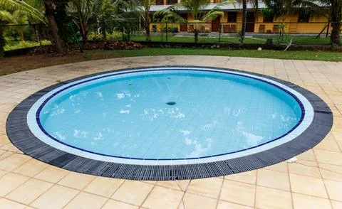 A small pool with a blue rim and a black border Stock Photos