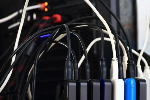 Small portable hard drives in stack connected to rear PC backup digital compu Stock Photos