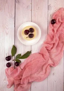 Small portion chessecake decorated with sweet cherries over on white wooden b Stock Photos