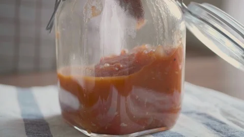 A small portion of the finished tomato sauce is contained in an airtight contain Stock Footage 113829021