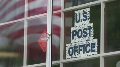 Small post office with flag reflected in window Stock Footage 49366333