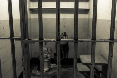 Small Prison Cell Behind Iron Bars At Alcatraz Island And Justice Concept Stock Photos