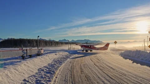 Small private airplane crossing public road and entering runway in Anchorage. Stock Footage 327842891