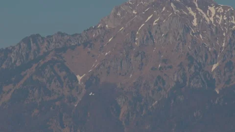 Small private airplane flying in front of majestic mountains Stock Footage 175150162