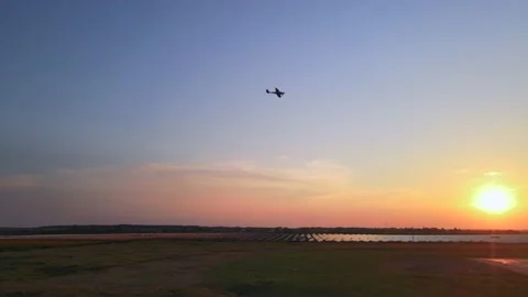 Small private airplane with propeller in front flying in blue sky at sunset Stock Footage 157891879