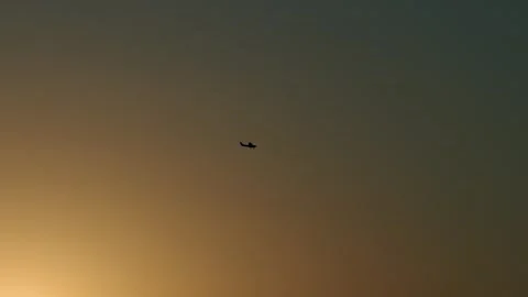 Small private airplane is tracked through golden sunset sky, copy space Stock Footage 313714245