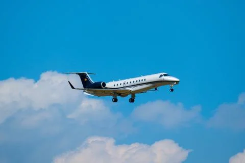 Small private jet airplane preparing for landing at day time in international Stock Photos