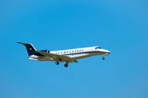 Small private jet airplane preparing for landing at day time in international Stock Photos